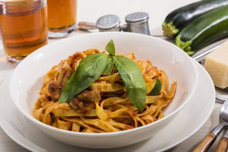 Photo for Plate of pasta with tomato sauce , zucchini and basil - Royalty Free Image