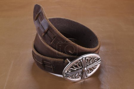 Photo for Brown leather belt with buckle on background - Royalty Free Image