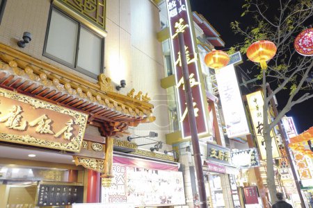 Photo for Illuminated shops on street of modern Japanese city - Royalty Free Image