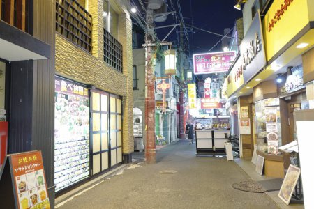 Photo for Illuminated shops on street of modern Japanese city - Royalty Free Image