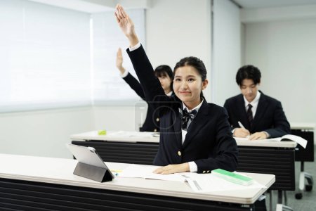 Photo for Japanese school students in uniform studying in classroom - Royalty Free Image
