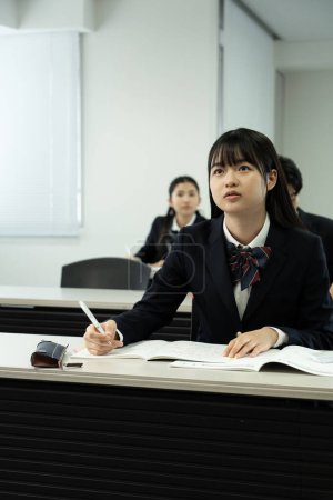 Photo for Japanese school students in uniform studying in classroom - Royalty Free Image