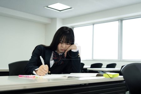 Photo for Female Japanese student studying in classroom - Royalty Free Image