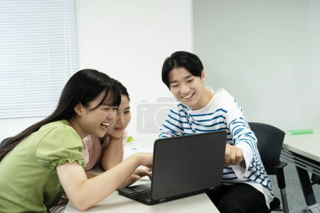 Photo for Japanese college students using laptop - Royalty Free Image
