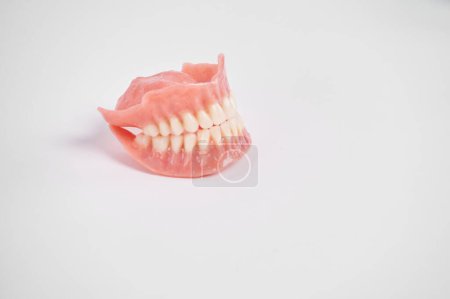 Photo for Dental prostheses on a white background. Beautiful teeth ceramic press ceramic crowns and veneers. Dental restoration treatment clinic patient. Oral surgery dentist - Royalty Free Image