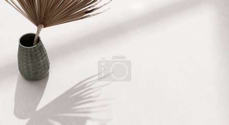 Photo for Blank space on white tablecloth, dried palm leaf in antique green square embossed pattern vase in sunlight, leaf shadow on table for luxury cosmetic, skincare, beauty treatment product background 3D - Royalty Free Image