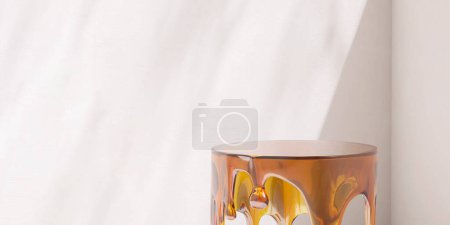 Photo for Round glossy brown transparent acrylic podium table with melting design of side in dappled sunlight, shadow on blank white wall for luxury cosmetic, skincare, beauty treatment product background 3D - Royalty Free Image