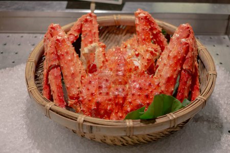 Red fresh steamed boil king crab leg from sea for delicious tasty seafood meal in store market restaurant, orange alaskan claw raw luxury crustacean animal for healthy gourmet in Japanese Asia pacific