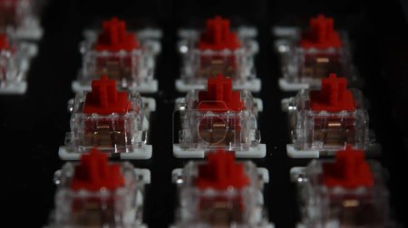 a close-up of the red switches with the keys of a mechanical keyboard ripped out