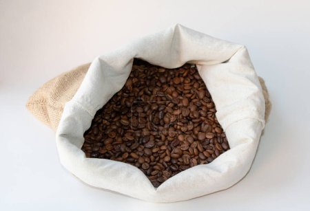 Foto de Granos de café en el saco. Granos de café en el saco aislados sobre fondo blanco - Imagen libre de derechos