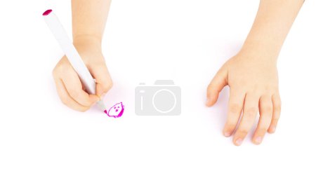Photo for Little artist in white t-shirt standing at table with whatman and colorful paints, painting on it with her hands. Isolated on white. Close-up - Royalty Free Image