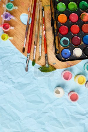 Photo for Flat lay of colorful paints, painting palette and brushes on blue background, art, painting and hobby concept, top view, copy space - Royalty Free Image