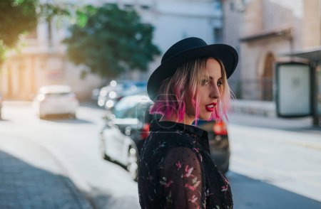 Photo for Portrait of young blonde with black hat and pink highlights. - Royalty Free Image