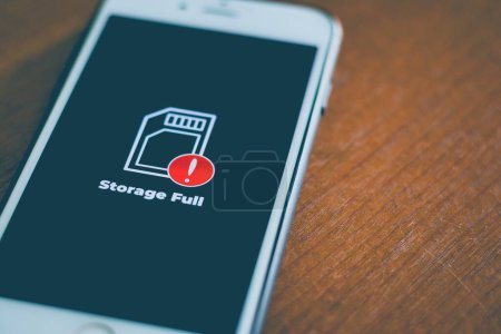 Photo for Smart phone with storage full icon on screen. Communication, cellular problem concept. - Royalty Free Image