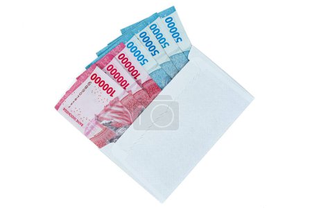 Indonesian rupiah currency. White envelope containing IDR 100,000 and IDR 50,000 cash isolated on white background