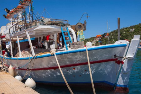 Vathy town, Meganisi island, Ionian Sea, GREECE-JULY 30, 2023: Fishing boat in Vathy Harbor. Close-up.