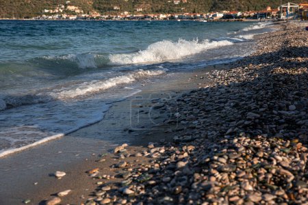 Sundy pebble beach with turquoise crystal clear water in Tyros town, Peloponnese, Argolic Gulf, Myrtoan Sea, GREECE in summer. Horizontal. Selective focus. 