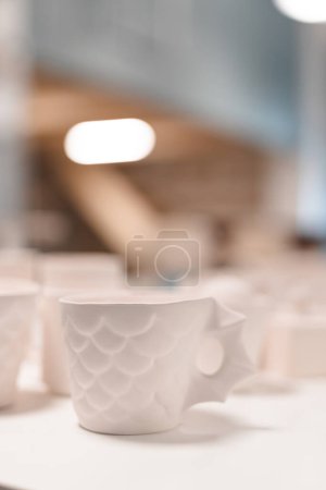 Photo for Selective focus of handmade ceramic mugs. arts and crafts concepts. vertical - Royalty Free Image