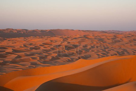 Photo for Sand dunes of the empty quarter, Rub Al Khali, UAE, in the low sunset. Orange colors. - Royalty Free Image