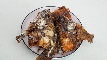 Fried fish served on a white plate