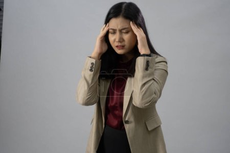 Téléchargez les photos : Portrait d'une jeune femme d'affaires asiatique avec maux de tête, plan de studio, concept d'entreprise, arrière-plan isolé - en image libre de droit