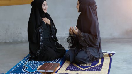 Photo for Portrait of an Asian muslim women in a daily prayer at home reciting Surah al-Fatiha passage of the Qur'an in a single act of Sujud called a Sajdah or prostration - Royalty Free Image