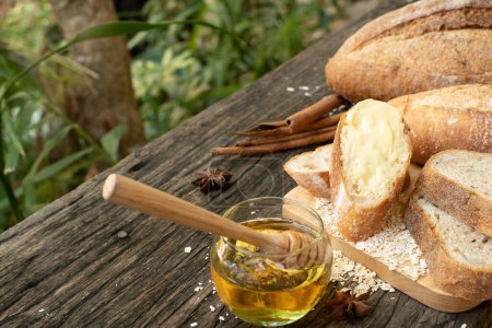 Photo for A closeup top view of freshly baked traditional Italian Ciabatta breads prepared and cut in to slices on a wooden table read to be served - Royalty Free Image
