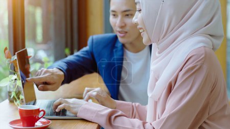 Photo for Upwardly mobile Asian Muslim business entrepreneur SME start up group of young man and women, discussing sale and marketing analysis, Asian Muslim SME teamwork e-commerce concept - Royalty Free Image
