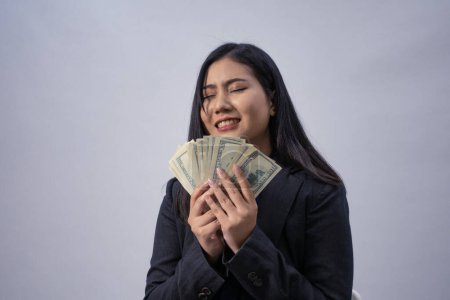 Photo for Portrait of a young Asian business woman with money, studio shot, business concept, isolated background - Royalty Free Image