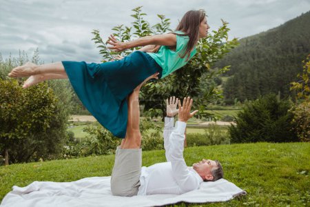 Photo for Yogi couple practicing a yoga posture in nature happily - Royalty Free Image