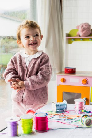 Photo for Baby girl smiling looking at the camera in the playroom at home - Royalty Free Image