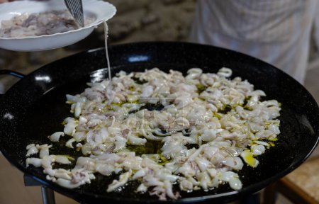 Photo for Close-up of cooking lots of squid in the fire pot at home - Royalty Free Image
