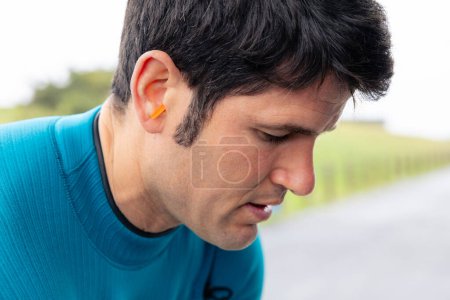 Photo for Portrait of a surfer with earplugs fitted for ocean protection. - Royalty Free Image