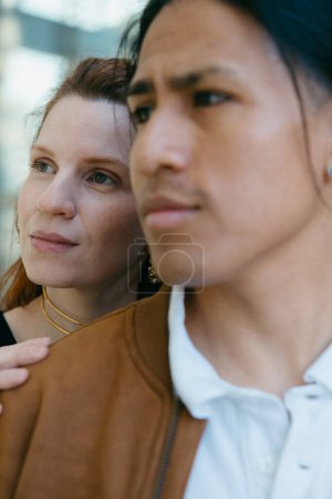 Close-up portrait of a contemplative couple, deeply enjoying the urban scenery, reflecting on the diverse beauty of city life.
