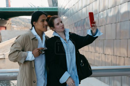 A happy couple captures a selfie moment while exploring the city, enjoying their travel adventure together