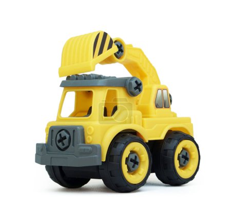Foto de Juguete amarillo de plástico para camiones aislado sobre fondo blanco. camión de construcción vechicle. - Imagen libre de derechos