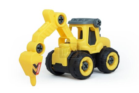 Foto de Juguete de taladro tractor de plástico amarillo aislado sobre fondo blanco. vehículo de construcción pesada. - Imagen libre de derechos
