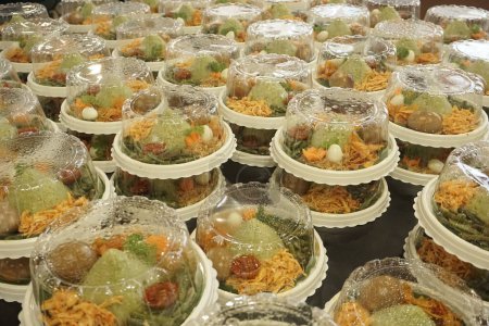 Small cone green shaped rice or Nasi tumpeng hijau mini in Indonesian culture is a food for festive or celebration of any moments.