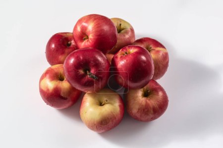 Close-up of a bunch of red apples on a white background. Healthy food concept. Natural products saturated with vitamins