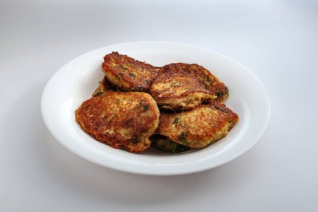 Traditional potato latkes, on a plate. Potato pancakes. Fried homemade potato pancakes or latkes