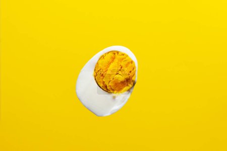Foto de Soft boiled egg. Chicken egg cut on a yellow background - Imagen libre de derechos