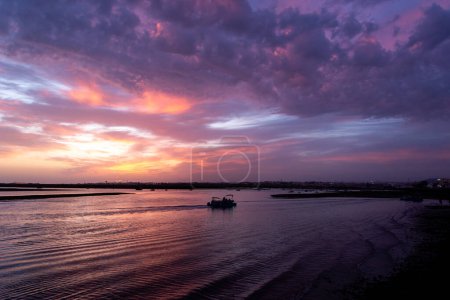 view of a colorful sunset over the sea in the evening in faro, algarve