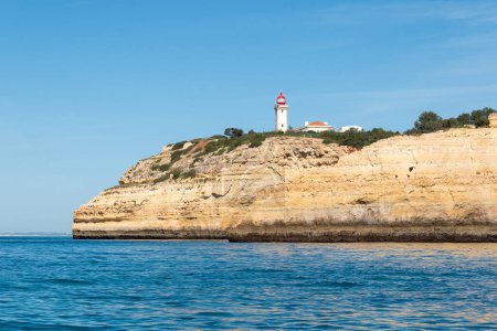 Algarve cliffs and lighthouse in  portugal