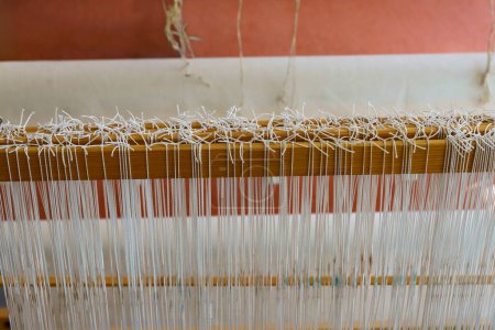Photo for Close-up of a floor loom warp threads and heddles for textile weaving - Royalty Free Image