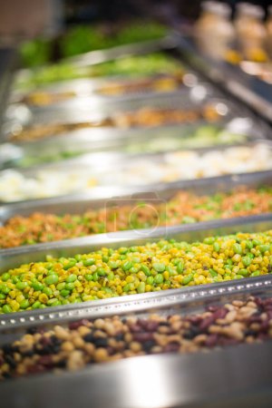 Photo for Yellow corn and green edamame mixed medley in a silver serving container at a food and salad bar. - Royalty Free Image