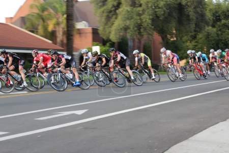 Photo for Redlands, California - March 24, 2012: Men cyclists race down Olive Avenue during the Redlands Bicycle Classic March 24, 2012 in Redlands, California. The first race was held in 1985. - Royalty Free Image