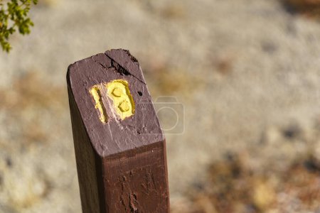 Photo for Trail Mile Marker Number Eighteen (18) carved on a wooden post and painted yellow - Royalty Free Image