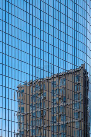 Photo for Blue glass skyscraper with the reflection of another building in the city - Royalty Free Image