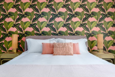 Photo for Bedroom with pink and green accent colors and tropical wallpaper theme - Royalty Free Image