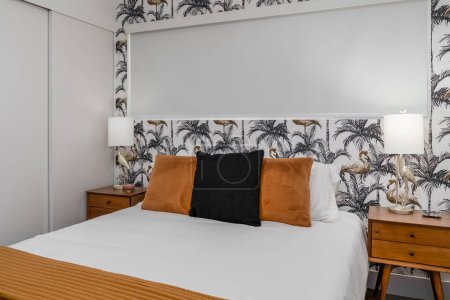 Photo for Brown and white bedroom interior with a palm tree and flamingo theme - Royalty Free Image